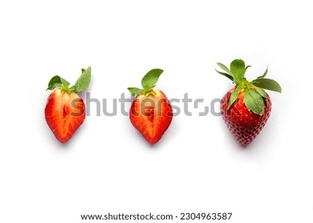 Strawberries on a white background. One whole berry and two halves of juicy fruit. Flat lay with Space for text.