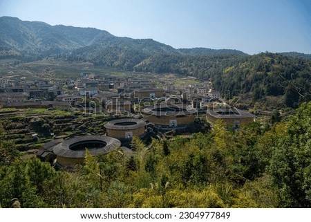 Aerial view of Chuxi Tulou cluster in Fujian, China. Translation of the captures from Chinese "Earth Buildings". Copy space for text
