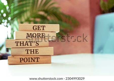 Wooden blocks with words 'Get more that's the point'.