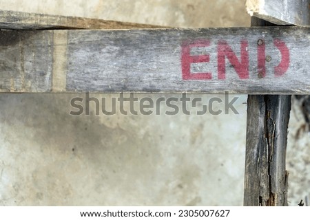 A red END message on the vintage wood.