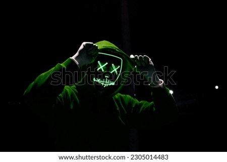 Neon Maskman picture with black background. Green Maskman.