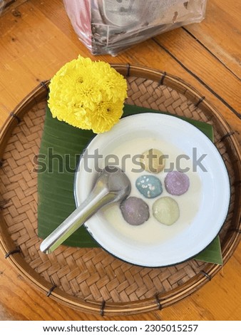 Thai dessert, made from flour multicolored and coconut milk called "kanom bualoi" On bamboo tray.  