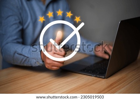 Customer rating and satisfaction concept, Man using laptop and touch virtual screen for give five star symbol to increase rating of product and service concept.