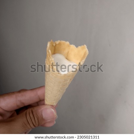 white ice cream with cream cone container
