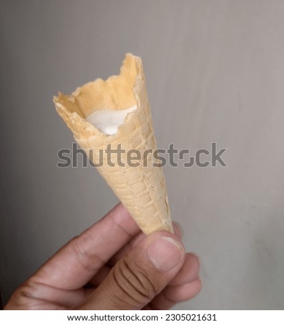 white ice cream with cream cone container