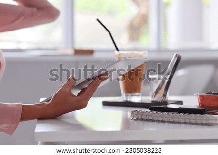 Young Asian businesswoman using laptop and notebook computers to work through internet to collect and organize investment documents. young businesswoman concept using technology to help investment
