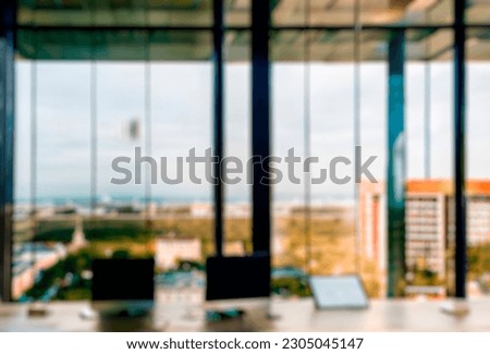 Blurred office workspace in the morning, interior workplace with cityscape for business presentation background