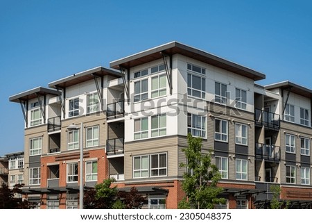 Facade of new residential townhouses. Modern apartment buildings in Vancouver Canada. Modern complex of apartment buildings in summer.Concept of real estate development, house for sale, housing market Royalty-Free Stock Photo #2305048375