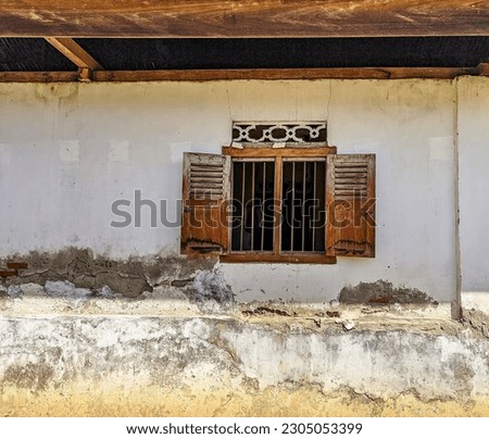 Old wooden window that opens, country house with old cracked concrete Royalty-Free Stock Photo #2305053399