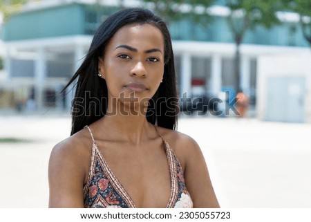 Portrait of beautiful south american woman with tradtional clothes outdoor in summer in city Royalty-Free Stock Photo #2305055723