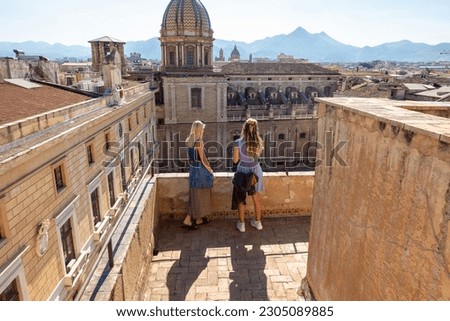 Couple of young women tourists, summer holiday in Italy on a romantic terrace in Palermo Panorama of Palermo at sunset on a sunny day in summer, Sicily. Italy Royalty-Free Stock Photo #2305089885
