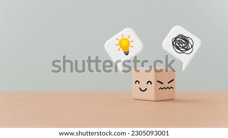 turned wooden cube block unhappy face  to happy with a tangle of thoughts and brighten lightbulb on white speech bubble, for creative, solution, problem solving concept Royalty-Free Stock Photo #2305093001