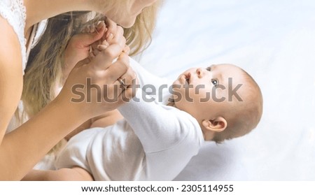 Mother with baby on a light background. Selective focus. People.