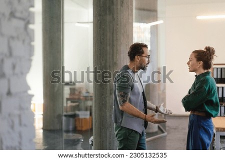 Colleagues arguing in office, problems at work. Royalty-Free Stock Photo #2305132535