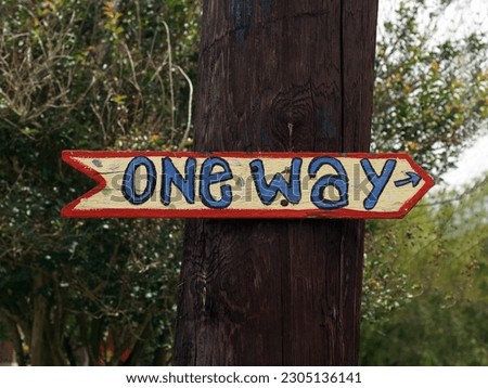                    one way sign on a tree              