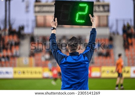 Sideline referee shows 2 minutes added time during the football match. Royalty-Free Stock Photo #2305141269