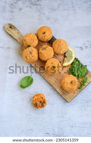  Home made Arancini bolognese . Italian fried rice balls with mozzarella cheese  minced meat  and fresh parsley. Italian street food. Royalty-Free Stock Photo #2305141359