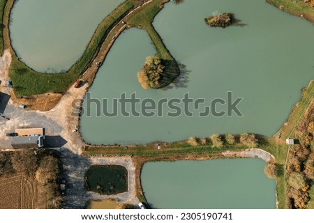 Sunny midday aerial shot of serene carp fishing lakes in Wexford, Ireland. Perfect for nature and travel projects