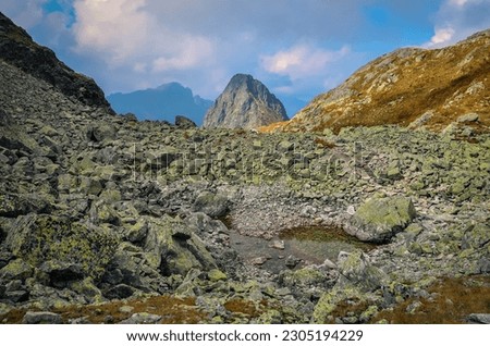 Summer mountain landscape in Slovak mountains. Stones in valley and rocky peaks in High Tatra Mountains, Slovakia.