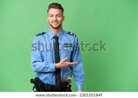 Young police man over isolated background presenting an idea while looking smiling towards