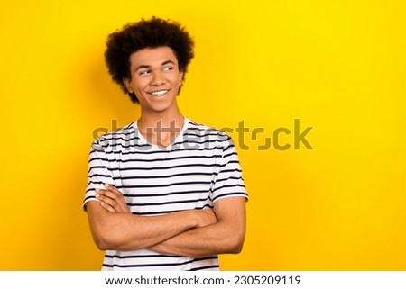 Portrait of cheerful youth guy look empty space arms folded wear striped white black t-shirt isolated yellow color background Royalty-Free Stock Photo #2305209119