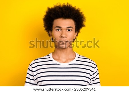 Portrait photo of young businessman wear striped t-shirt funny hairstyle chevelure confident serious face isolated on yellow background