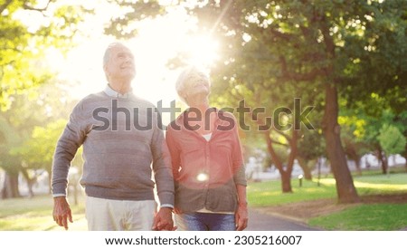 Senior couple, holding hands and walking outdoor at a park with love, care and support. A elderly man and woman in nature for a walk, quality time and hope for a healthy marriage or retirement