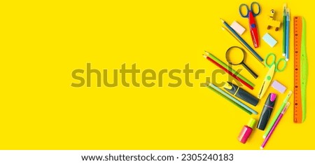 Banner on yellow background flat mockup of stationery for school, colored pencils, felt-tip pens, ruler, eraser, scissors.  Back to school concept.  Space for copy text.
