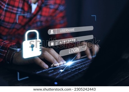 A man's hand presses the laptop keyboard and the screen appears to enter the username and password to log in to the system. Cyber security for information technology ISO IEC 27001 and 27002 concept. Royalty-Free Stock Photo #2305242443