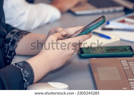 Woman typing on mobile phone, closeup on hands. High quality photo.