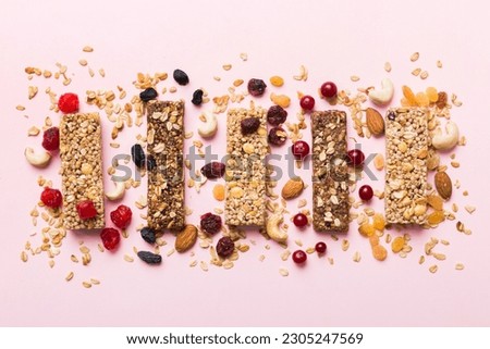 Various granola bars on table background. Cereal granola bars. Superfood breakfast bars with oats, nuts and berries, close up. Superfood concept. Royalty-Free Stock Photo #2305247569