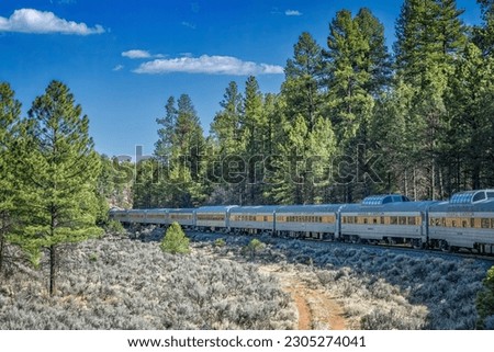 A view of the Grand Canyon railway train heading into a curve during its return trip to Williams from the south rim of the Grand Canyon in Arizona Royalty-Free Stock Photo #2305274041
