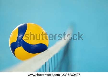Blurred photo in action of a volleyball near the net. Playing volleyball, ball reaching opponents side of the net Royalty-Free Stock Photo #2305280607
