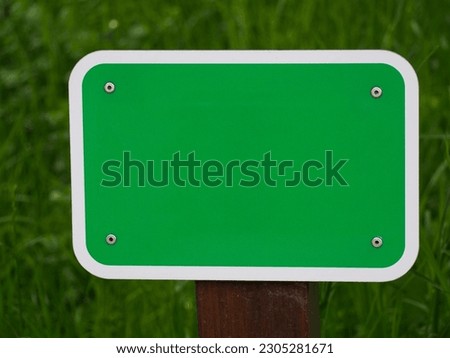 Blank sign for your own design with green background