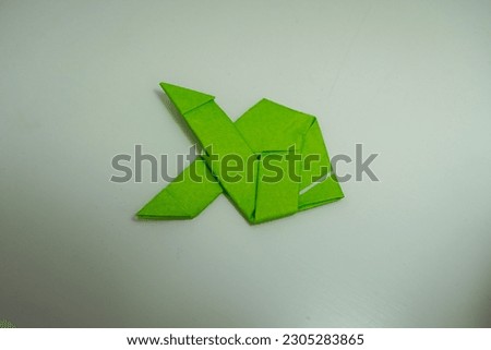 Origami like fish made with green paper
