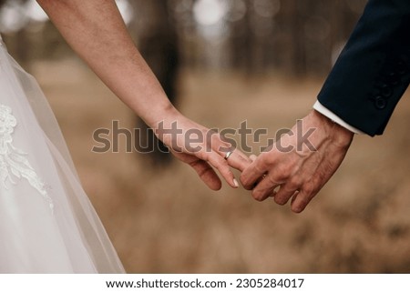 The newly married couple holding hands Royalty-Free Stock Photo #2305284017
