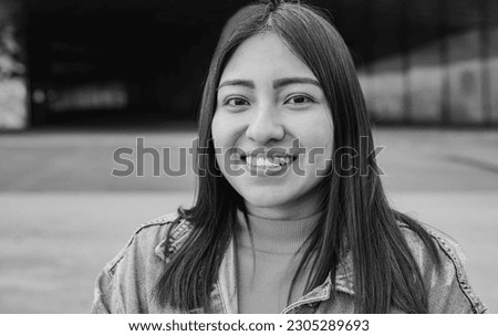 Portrait of indigenous young woman smiling on camera outdoor - Black and white editing Royalty-Free Stock Photo #2305289693