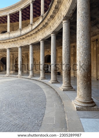 A vertical shot of the columns of the Palace of Charles V in Granada, Spain