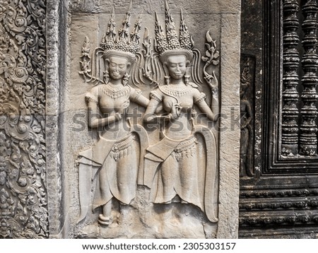 An image of women that are pictured on a stone in Angkor Wat, Cambodia