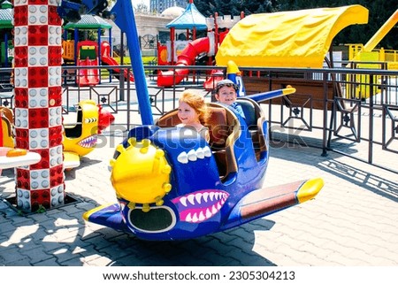 children on the airplane carousel attraction Royalty-Free Stock Photo #2305304213