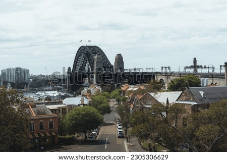 The view of buildings before the Sydney Harbour bridge on a cloudy day