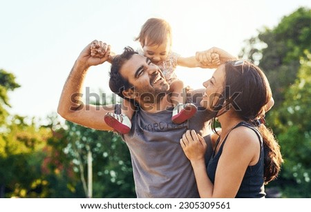 Family, dad and daughter on shoulders in park with mom, happiness or love in summer sunshine. Young couple, baby girl or laugh together for freedom, bond or holding hands for care, backyard or garden Royalty-Free Stock Photo #2305309561