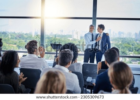 Professional, presentation and applause during a seminar at the workplace with people in the audience. Business, employees and congratulations during conference for awards in career at the office. Royalty-Free Stock Photo #2305309673