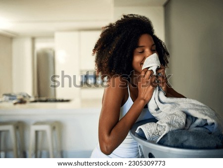 Laundry smell, African woman and home cleaning chores with happiness and calm. Smile, fresh clothes and happy with housekeeping of a black female person in a house feeling relax in the morning Royalty-Free Stock Photo #2305309773