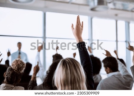 Conference, group and business people with hands for a vote, question or volunteering. Corporate event, meeting and hand raised in a training seminar for questions, voting or audience opinion Royalty-Free Stock Photo #2305309909