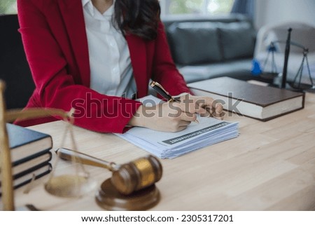 woman in red suit Lawyers signing documents at the office Lawyer consultant, justice and law, attorney, court judge, concept.