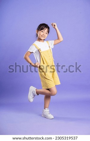 cute asian baby girl posing on purple background