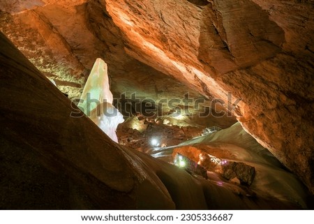 Massive ice formations and a tall iced pinnacle inside the Parzivaldom at the Dachstein Rieseneishöhle, a giant ice cave in the Austrian Alps Royalty-Free Stock Photo #2305336687