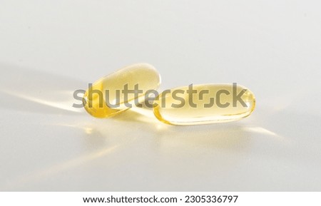 Fish Oil Omega 3 on white background, vitamin D yellow supplement gel capsules, macro shot Royalty-Free Stock Photo #2305336797