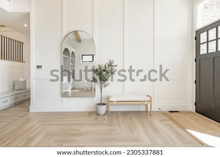 Living room interior with white decor arched mirror and built in shelving warm white tone minimalist Royalty-Free Stock Photo #2305337881